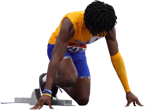 Track runner kneeling at blocks.